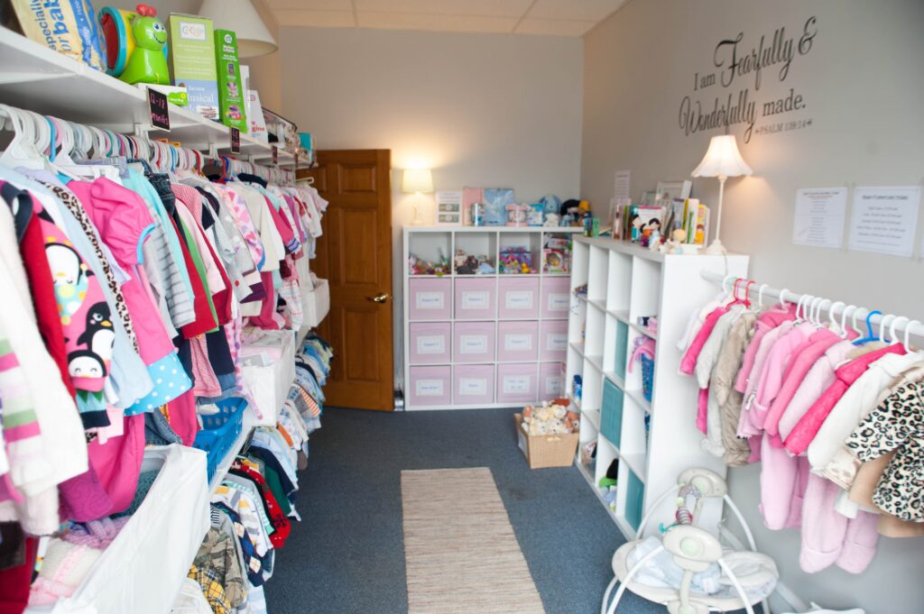 room with children's clothes on racks